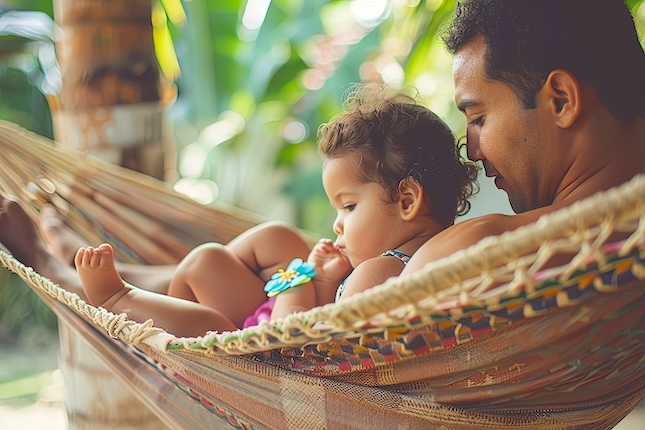 man-holding-baby-hammock